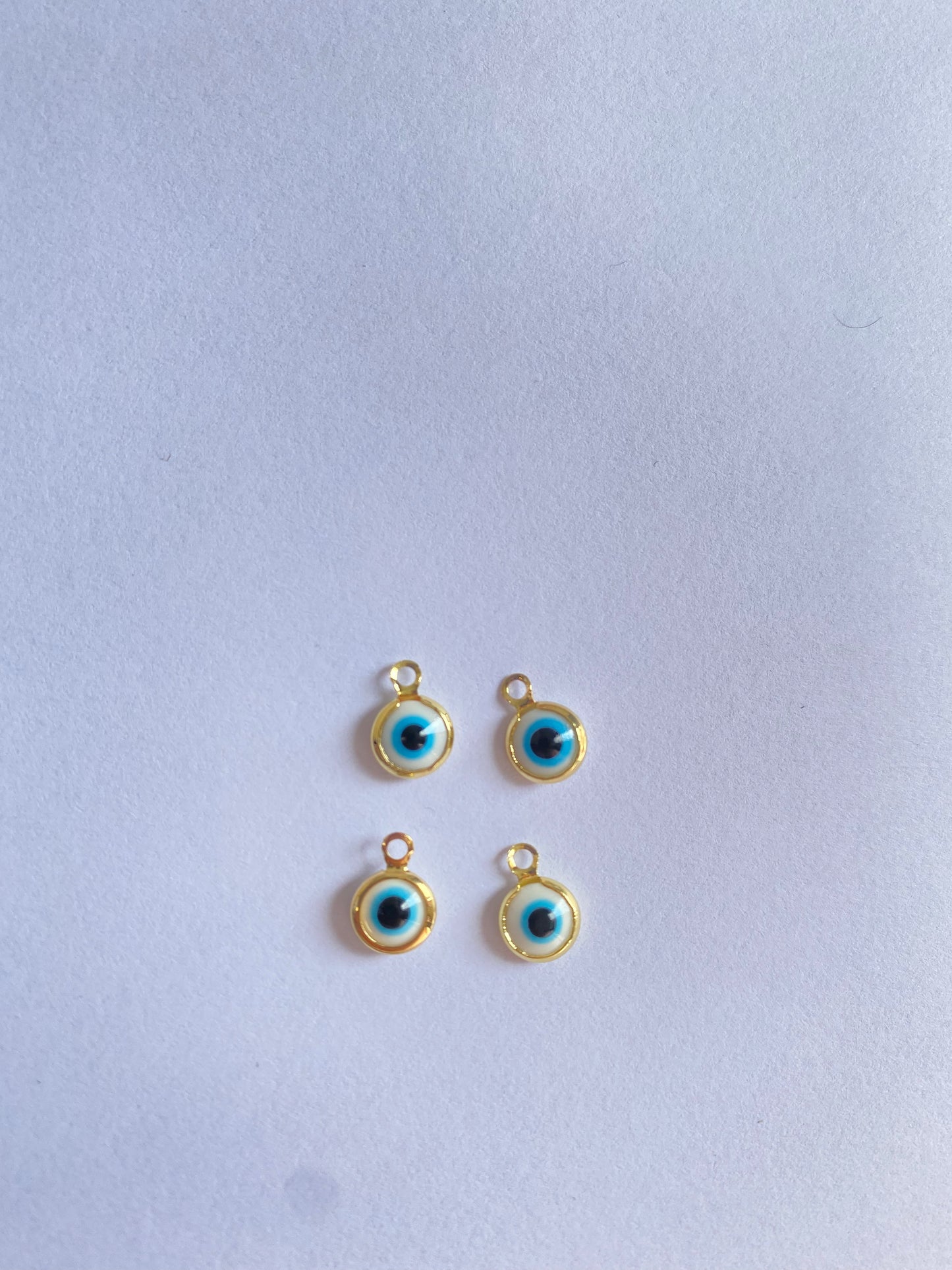 gold white eye charm